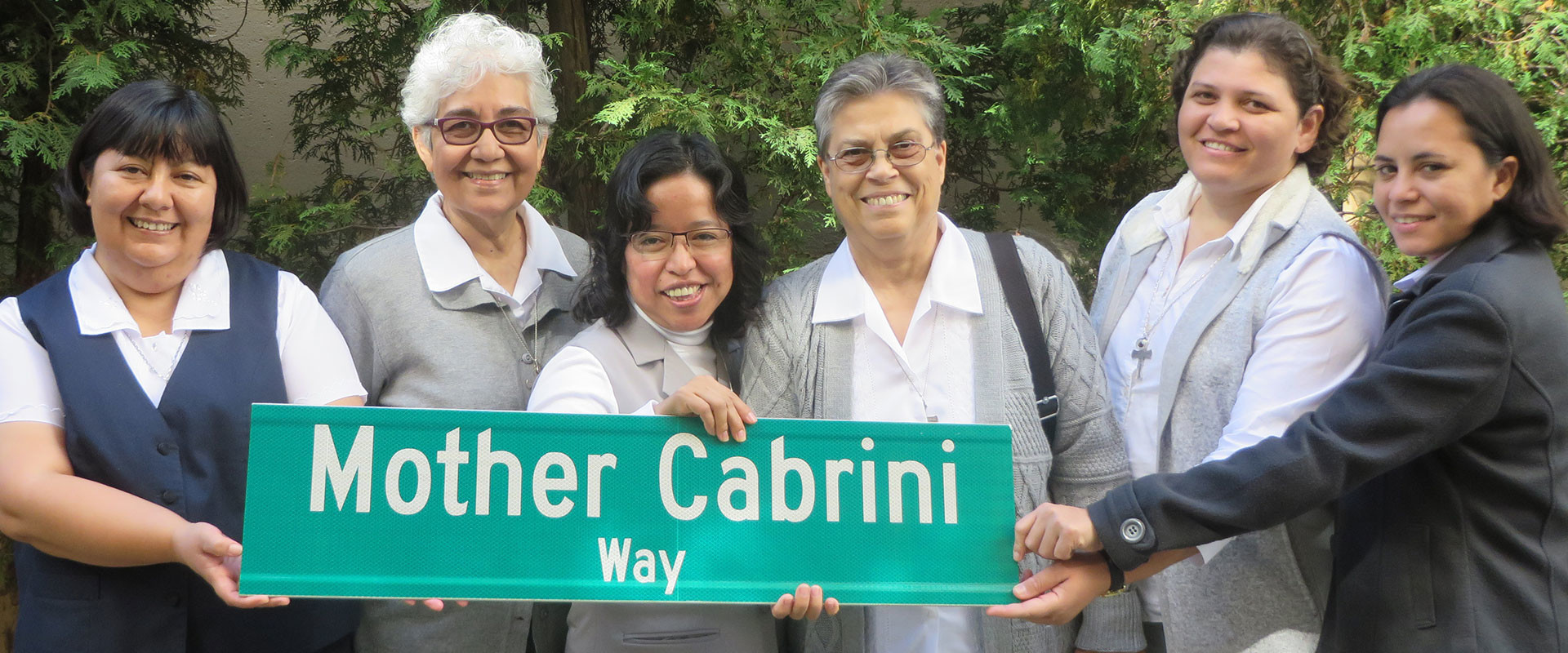 Missionary Sisters with Mother Cabrini Way street sign