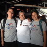 Three members of Cabrini Immigrant Services at Bowling Alley fundraiser