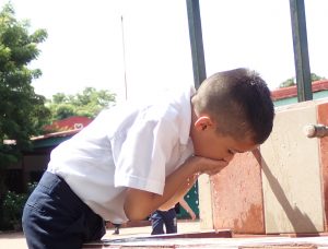 La Inmaculada student drinking from well.
