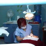 Dentist working on a patient with open mouth