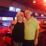 Bowling FUNdraiser couple posing in front of lanes