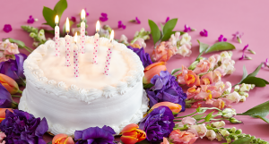 Birthday cake with candles and flowers
