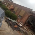 House with roof severely damaged by tornadoes