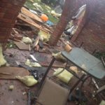 House with roof severely damaged by tornadoes