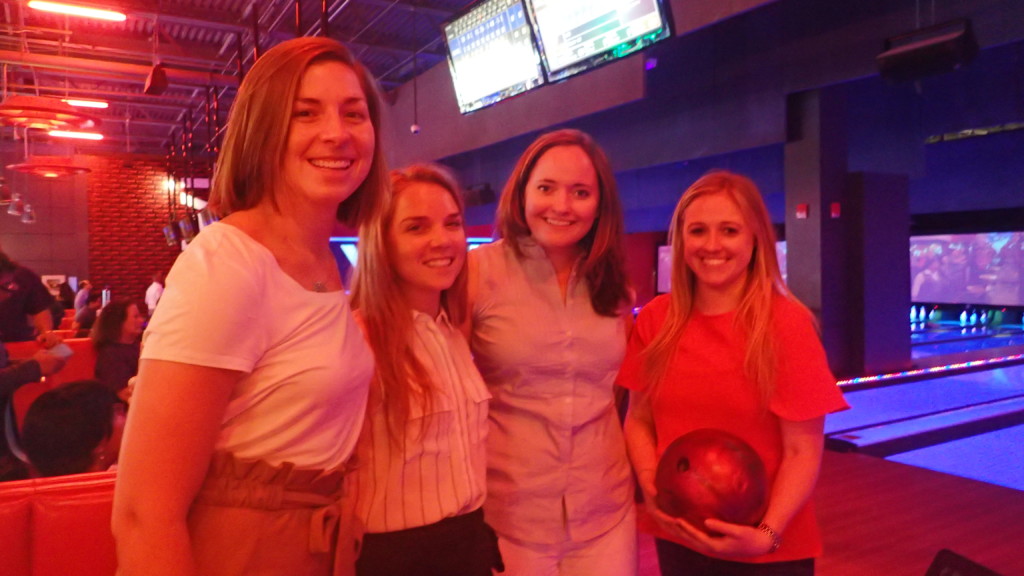 2018 Bowling FUNdraiser group photo at bowling alley, woman holding bowling ball