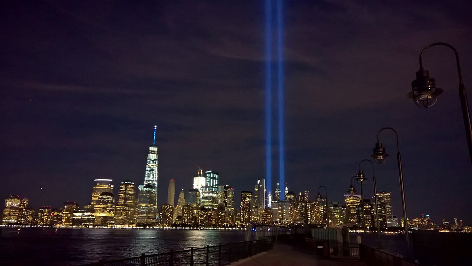 Prayer of Remembrance on 9/11 - NYC skyline with two blue towers of light