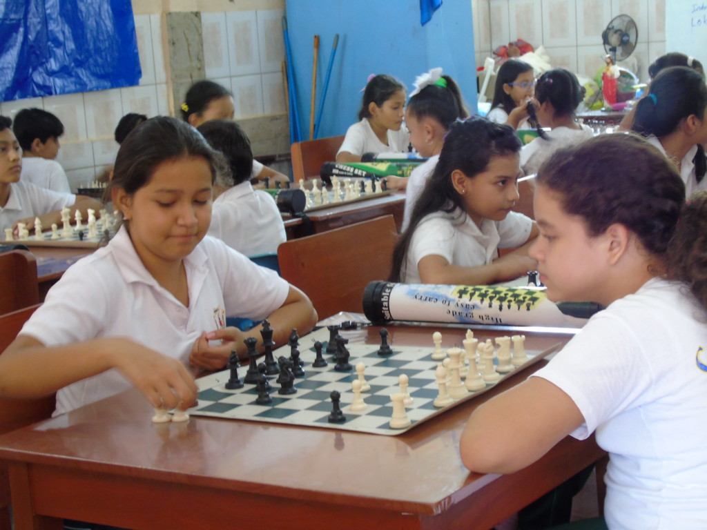 Students play chess with one another an an all girls school