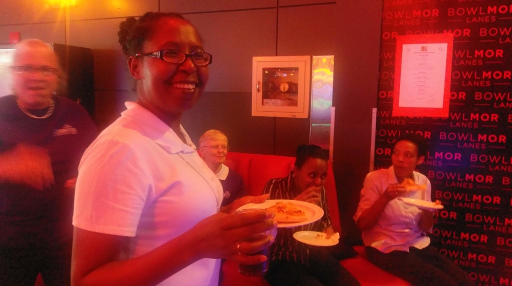 Cabrini Mission Attendees at 2019 Bowling Event holding plates of pizza