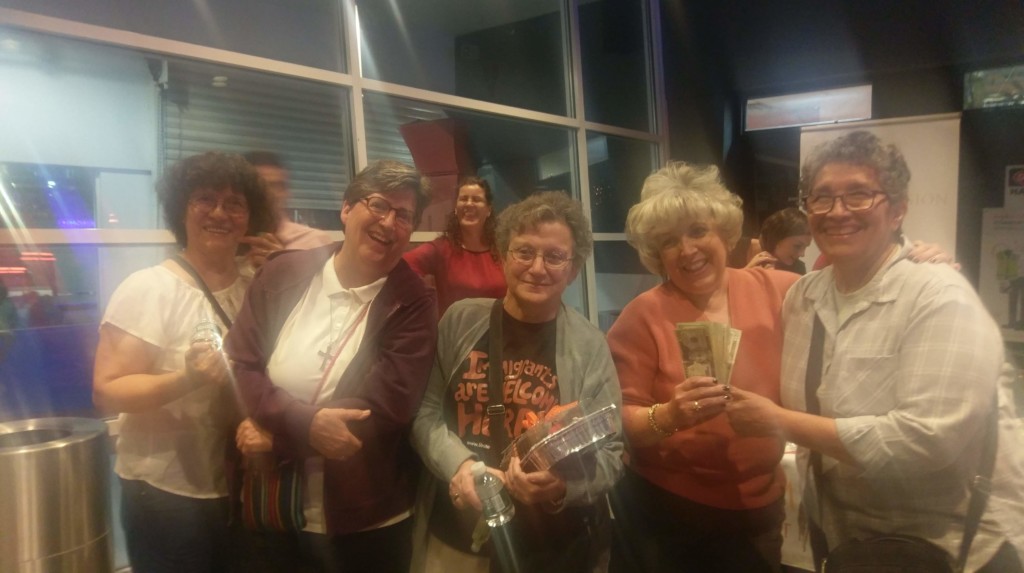 Cabrini Mission 2019 Bowling Event 5 women posing for photograph with handful of cash