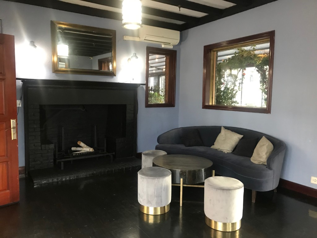 Fireplace and couch with table and chairs