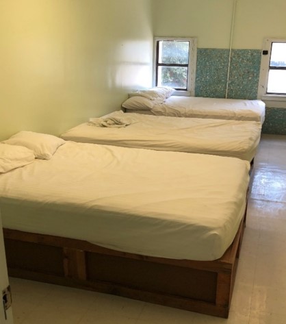 Three matching beds in a room