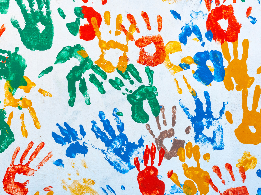 Colorful paint handprints on a white background